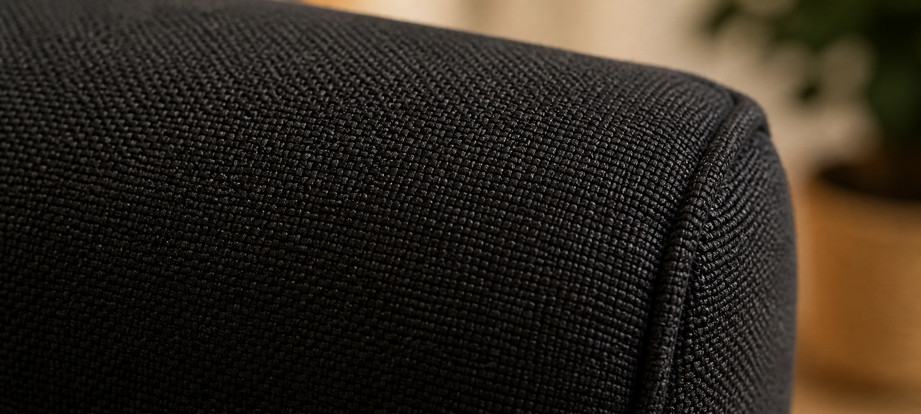 Black fabric couch showing woven textile texture