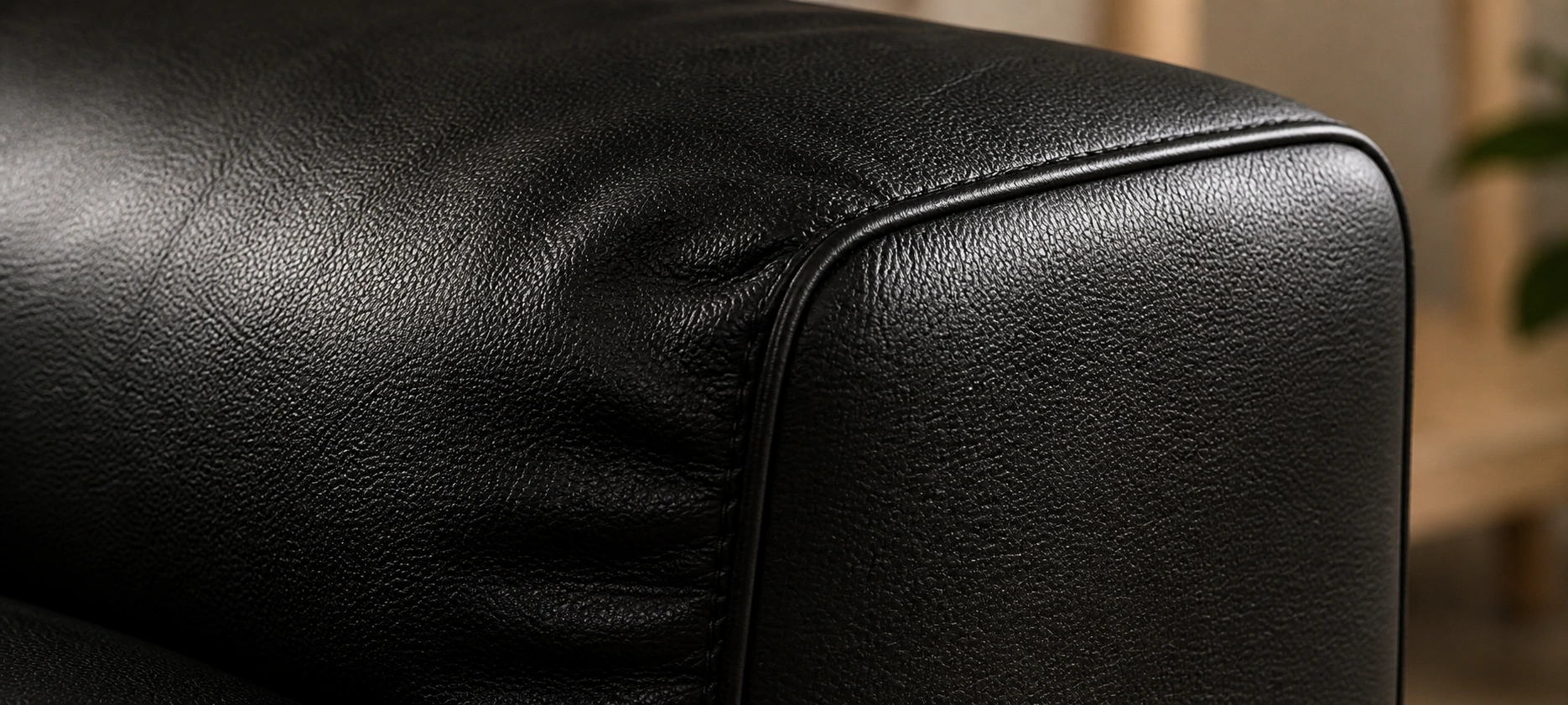 Close-up of black leather couch texture showing grain