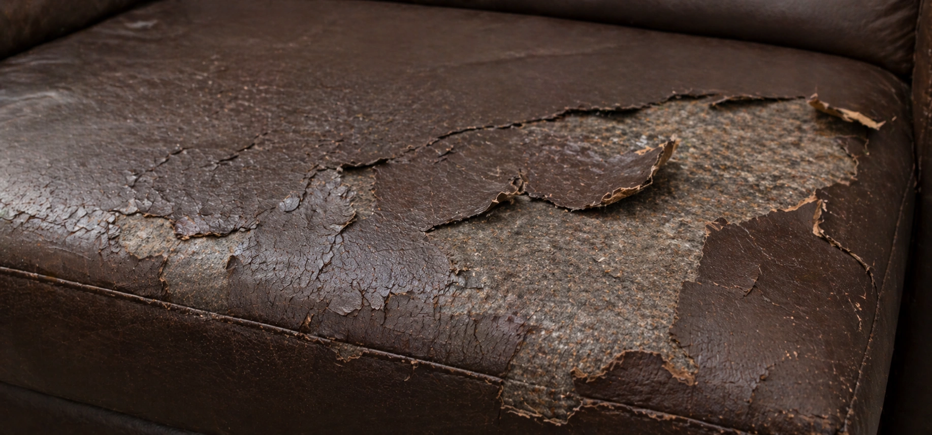 Bonded leather sofa showing peeling and cracking surface after a few years of use
