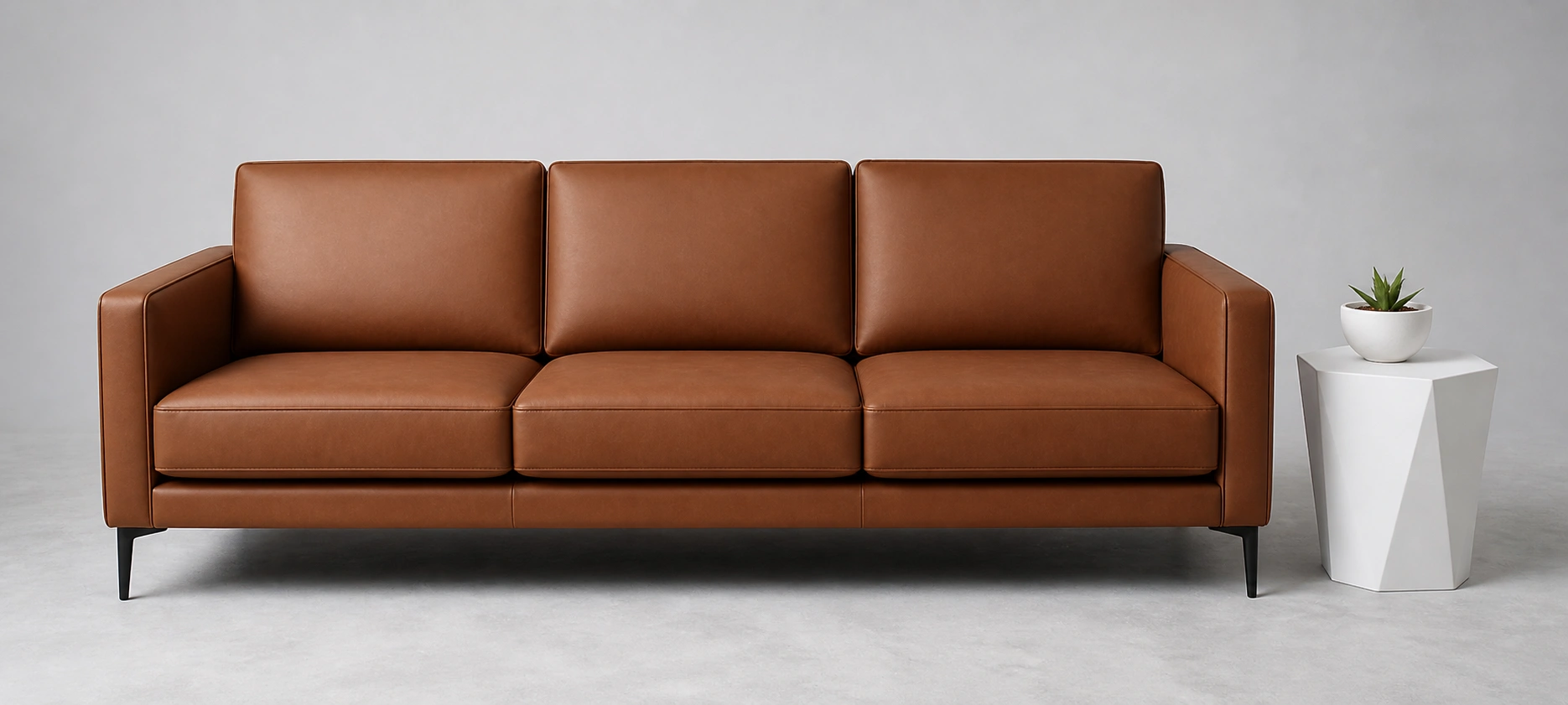 Brown faux leather couch with clean modern lines and uniform finish