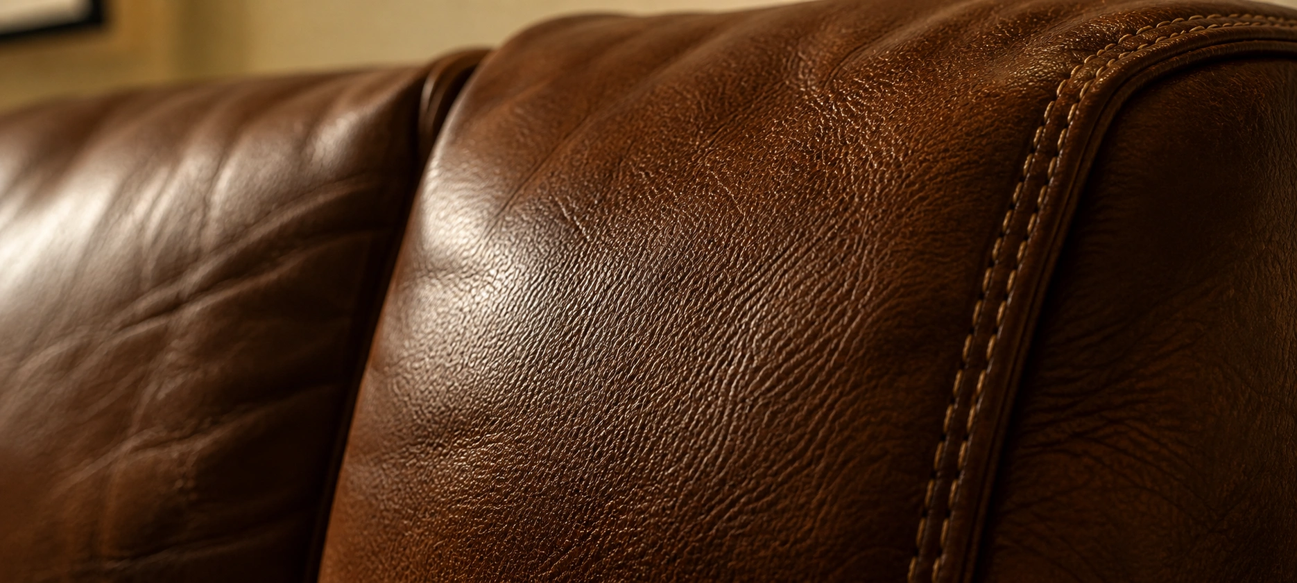 Brown genuine leather couch showing natural grain texture and warm patina