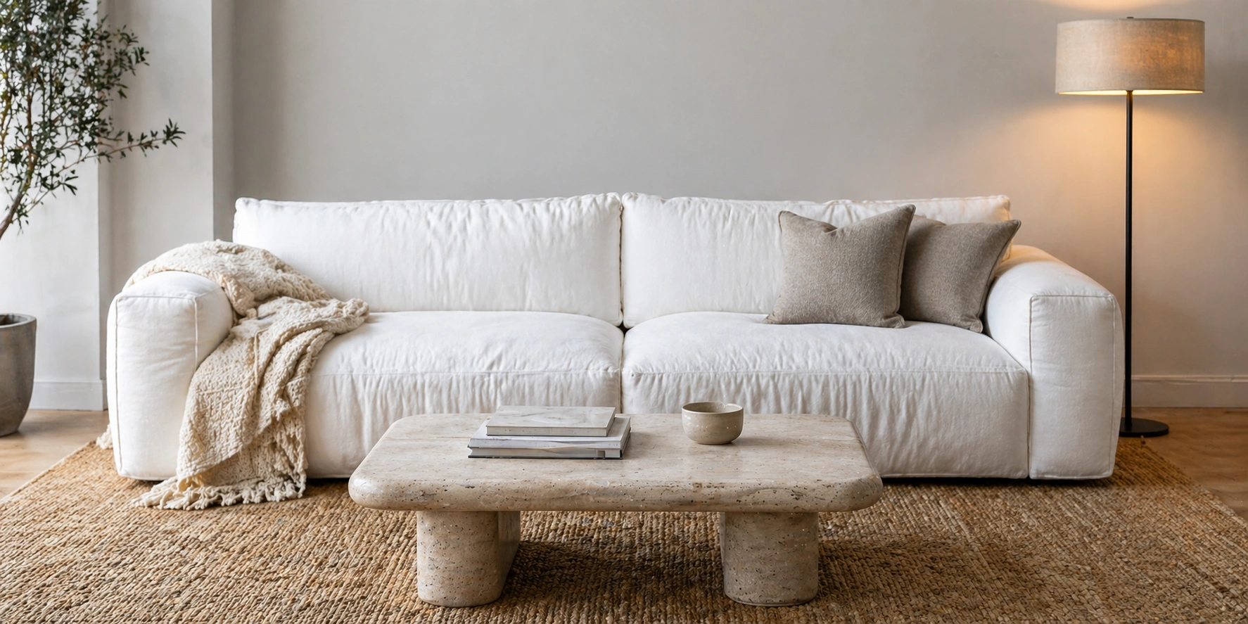 White cloud couch in a modern living room with neutral decor