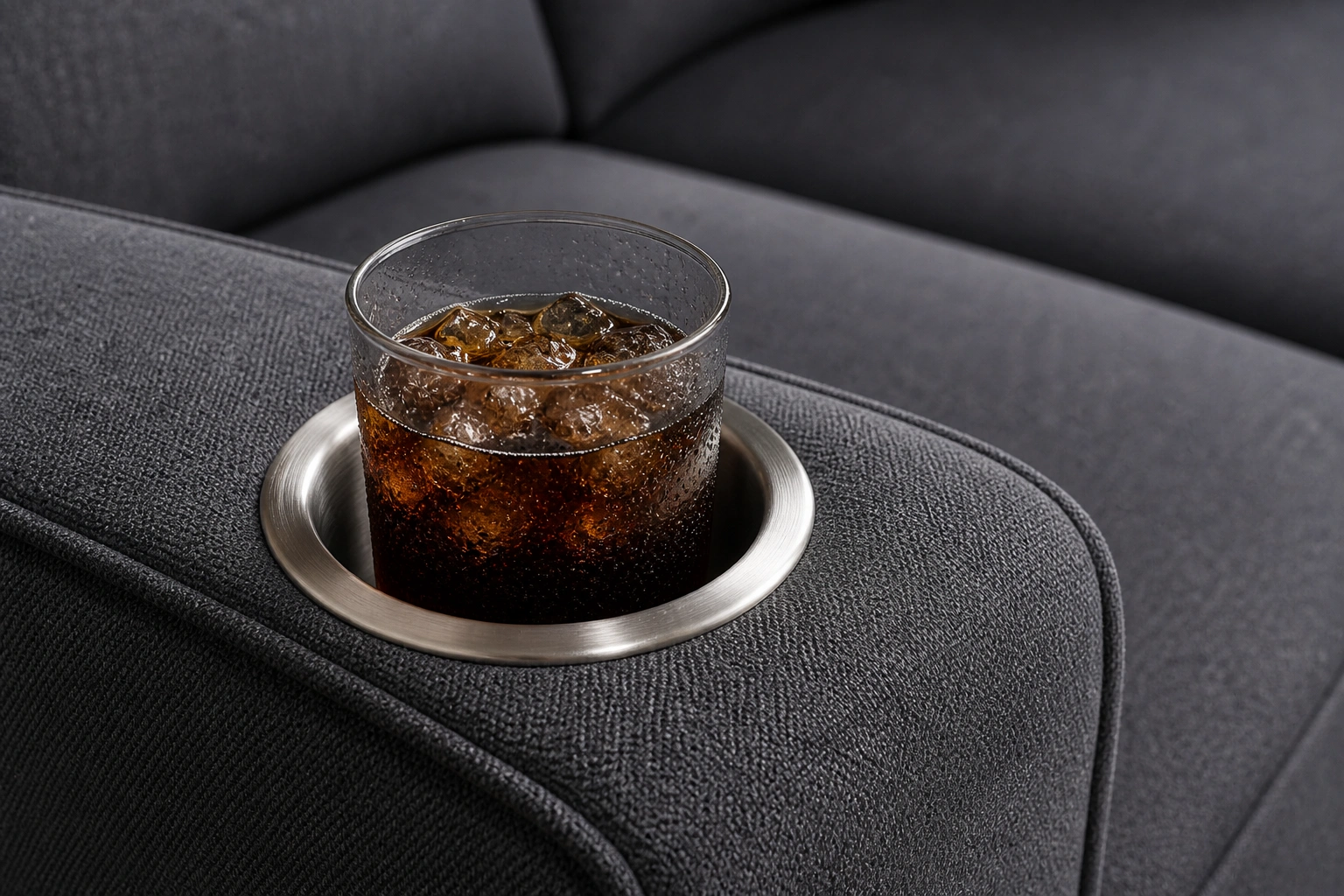 Close-up of built-in cup holders on a sofa armrest