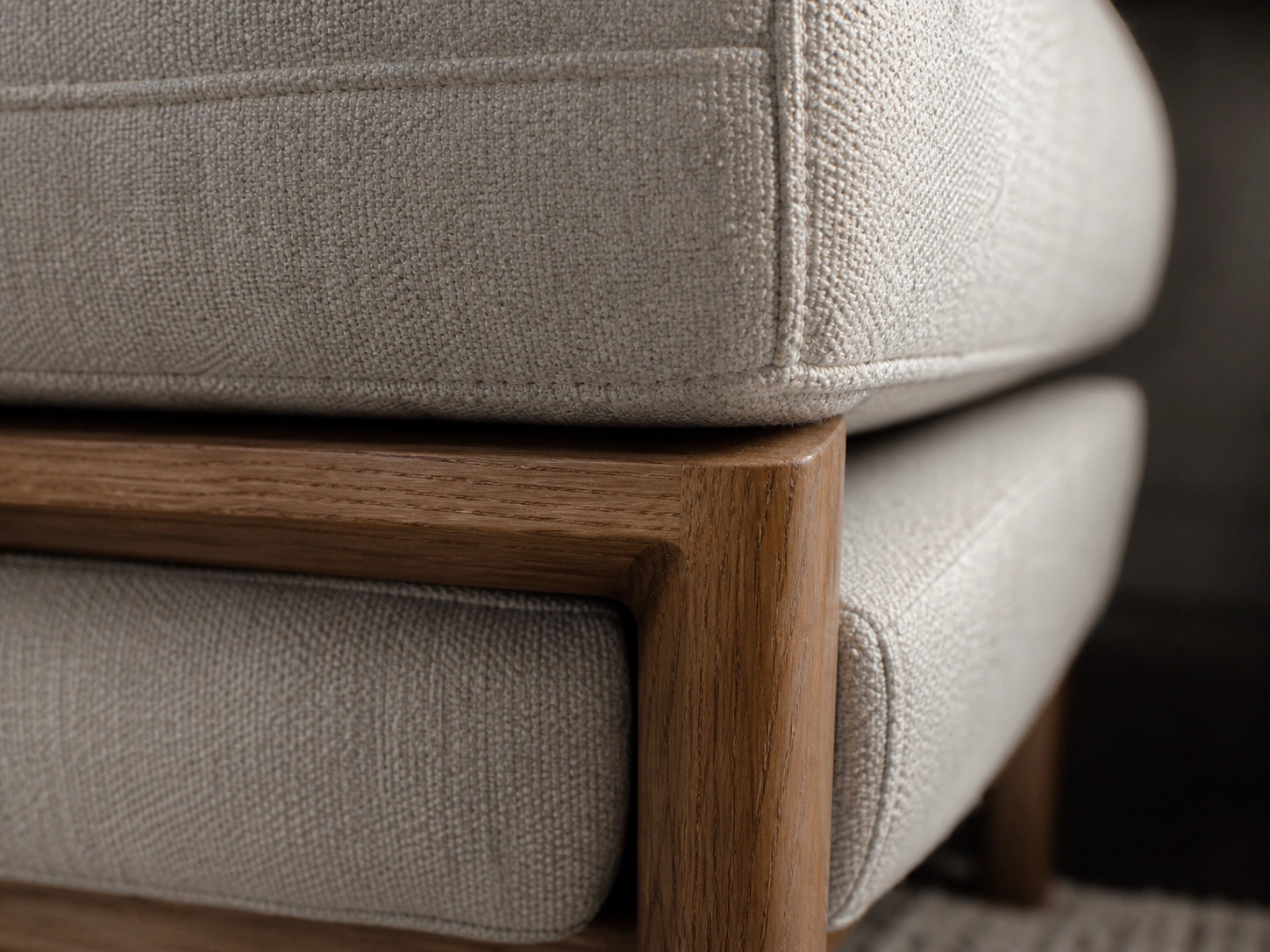 Close-up of durable upholstery fabric and solid wood frame on a large sofa