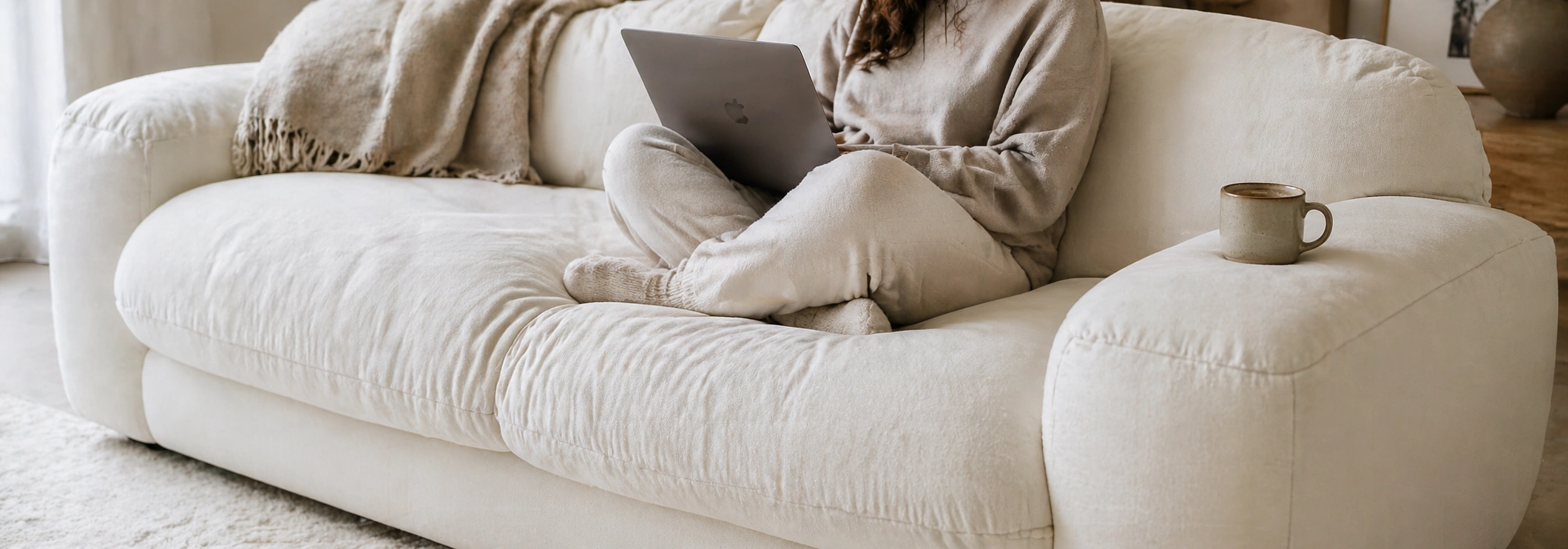 Person curled up on a deep seat sofa