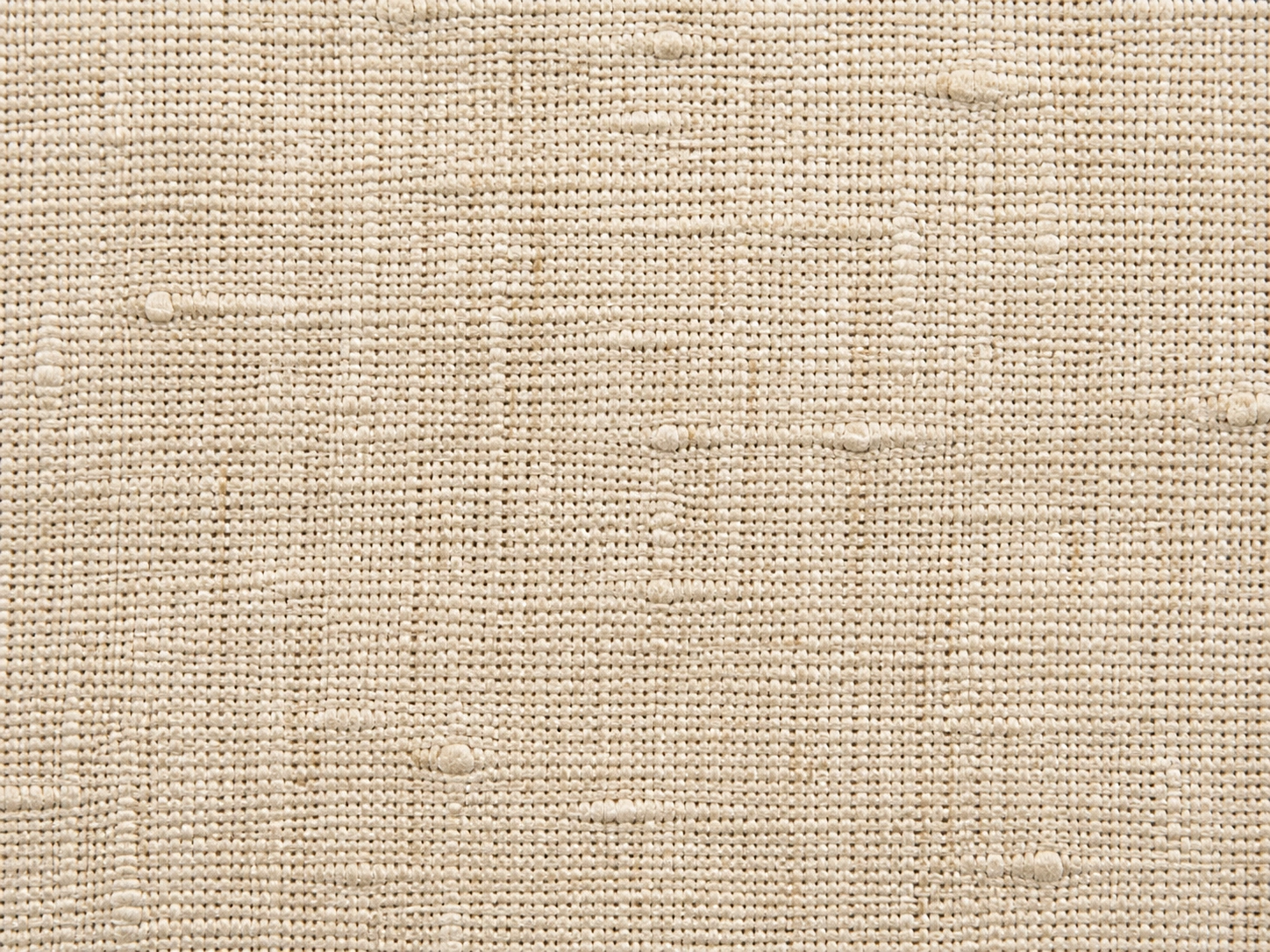 Close-up of natural linen fabric texture showing woven flax fibers