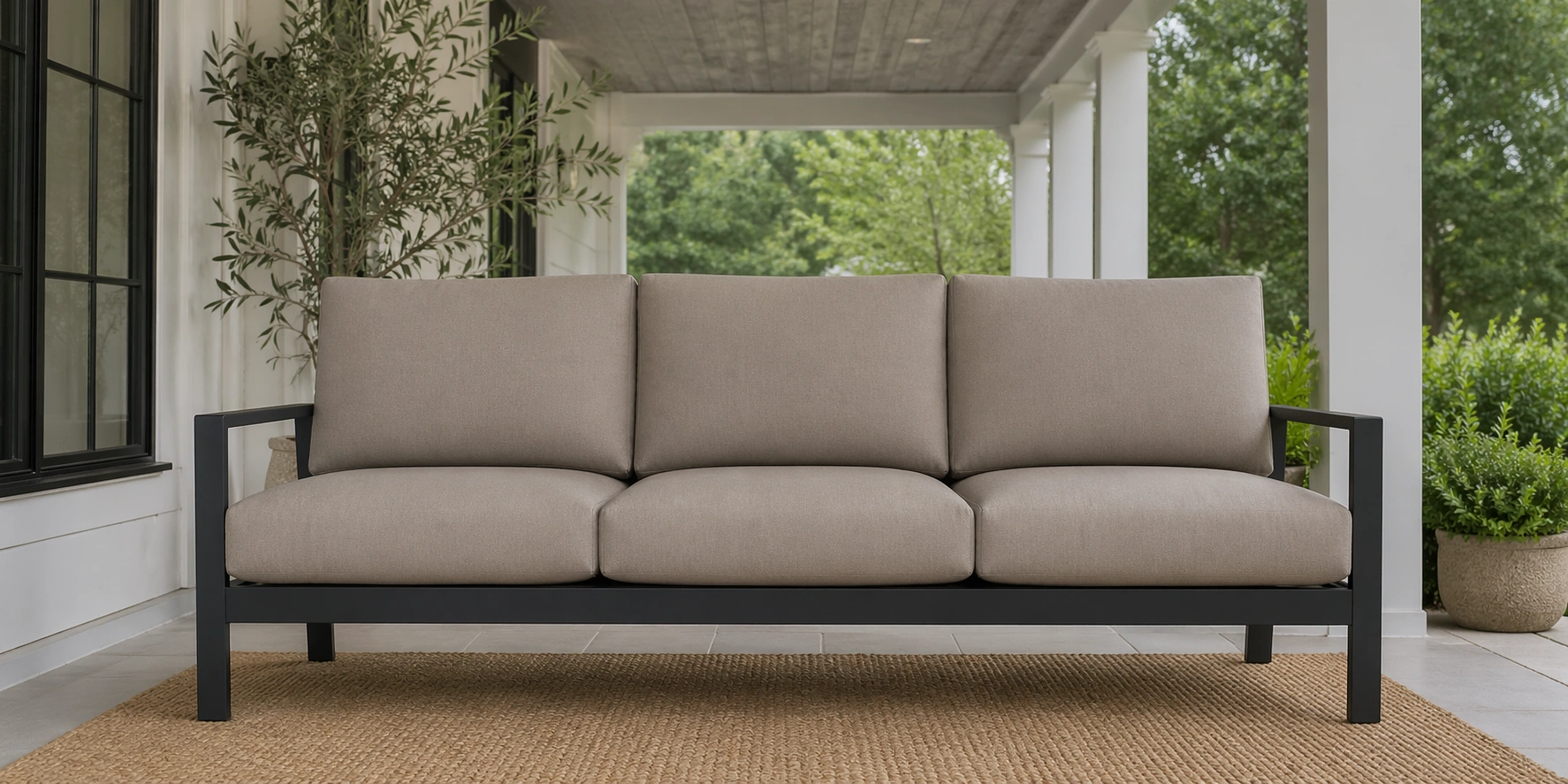 Three-seater outdoor sofa with neutral cushions
