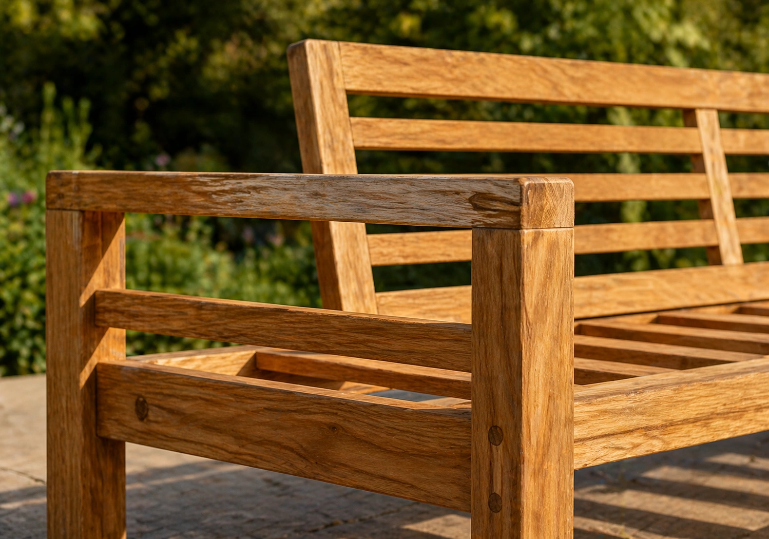 Teak wood outdoor sofa frame showing natural grain and weathered finish