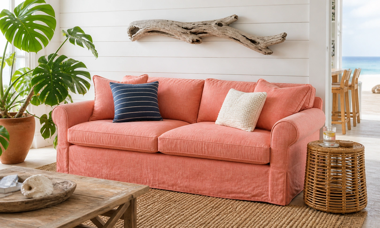 Salmon pink couch in a bright coastal-style room with natural textures