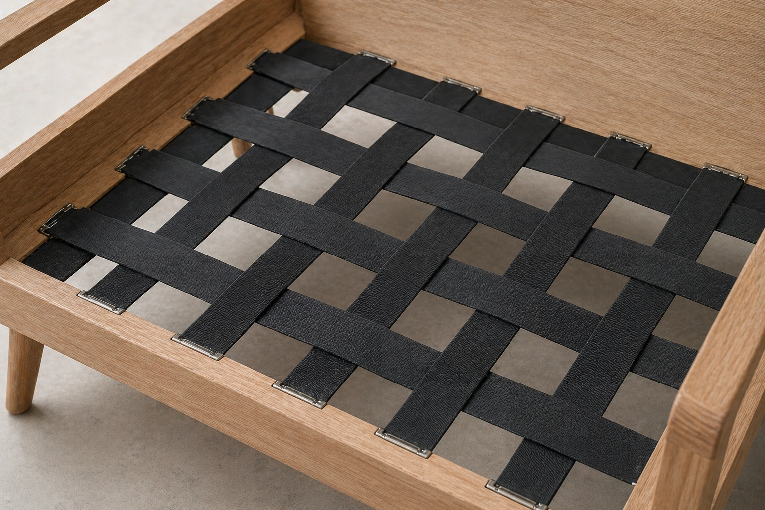 Rubber Pirelli webbing strips stretched across a sofa frame for support