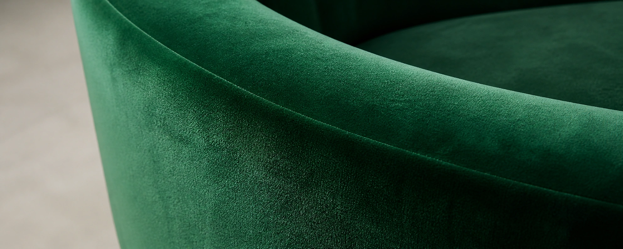 Round velvet sofa in emerald green showing soft texture
