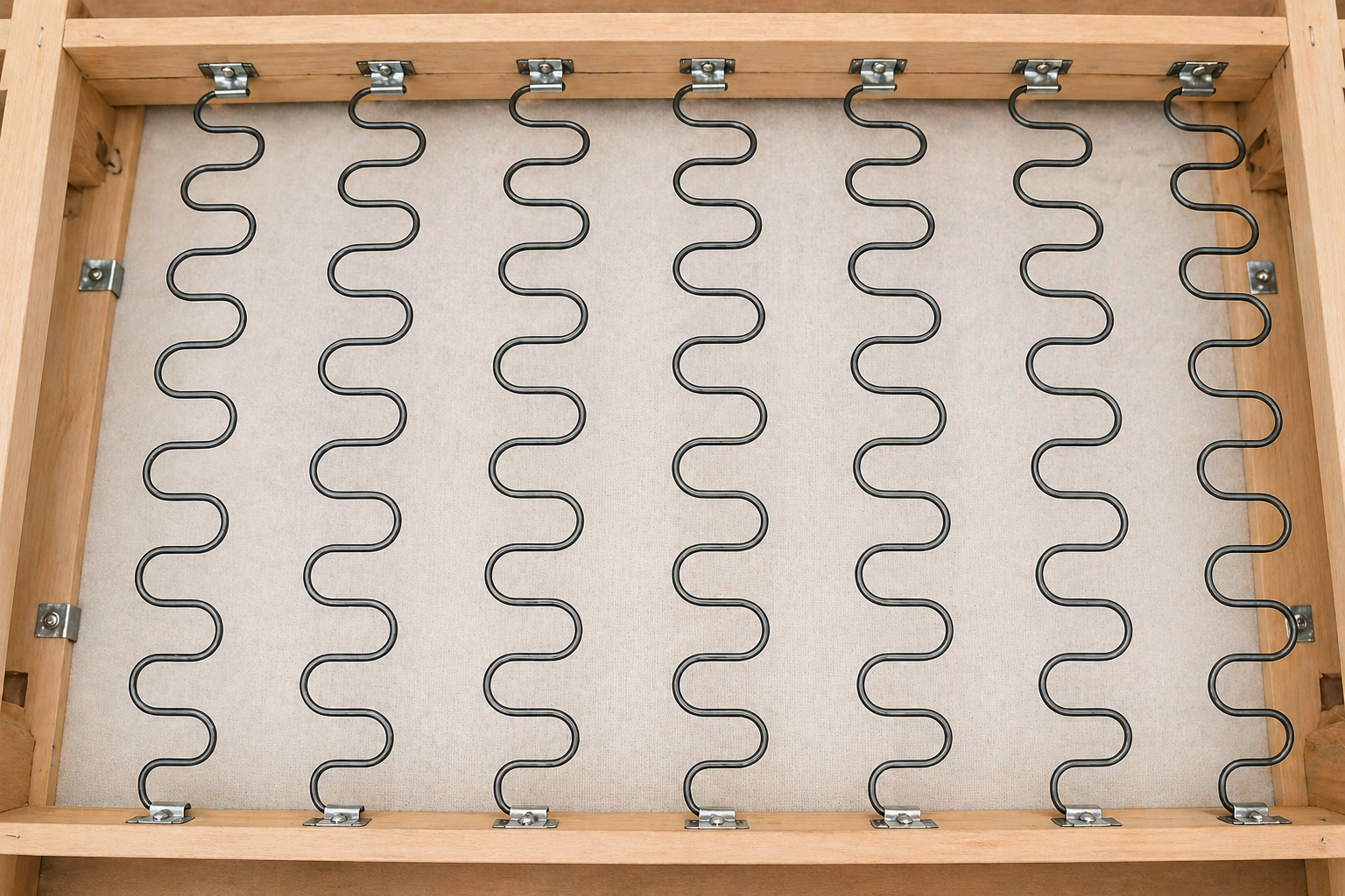 Sinuous S-type zigzag springs attached to a sofa frame rail