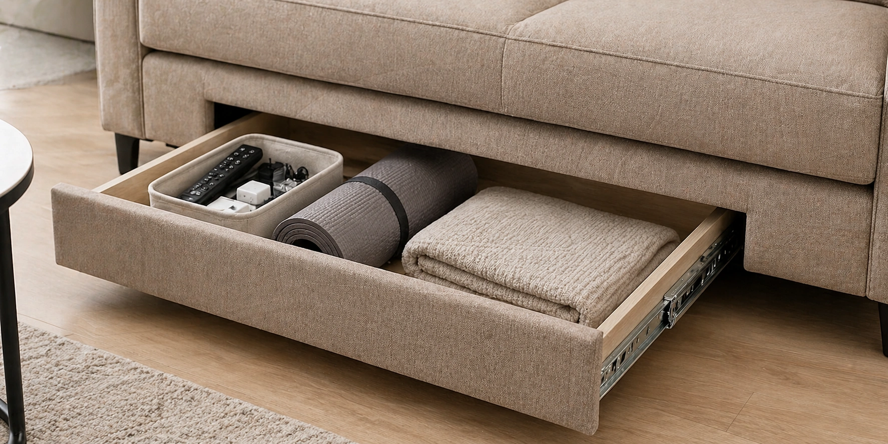 Pull-out drawer storage at the base of a modern sofa