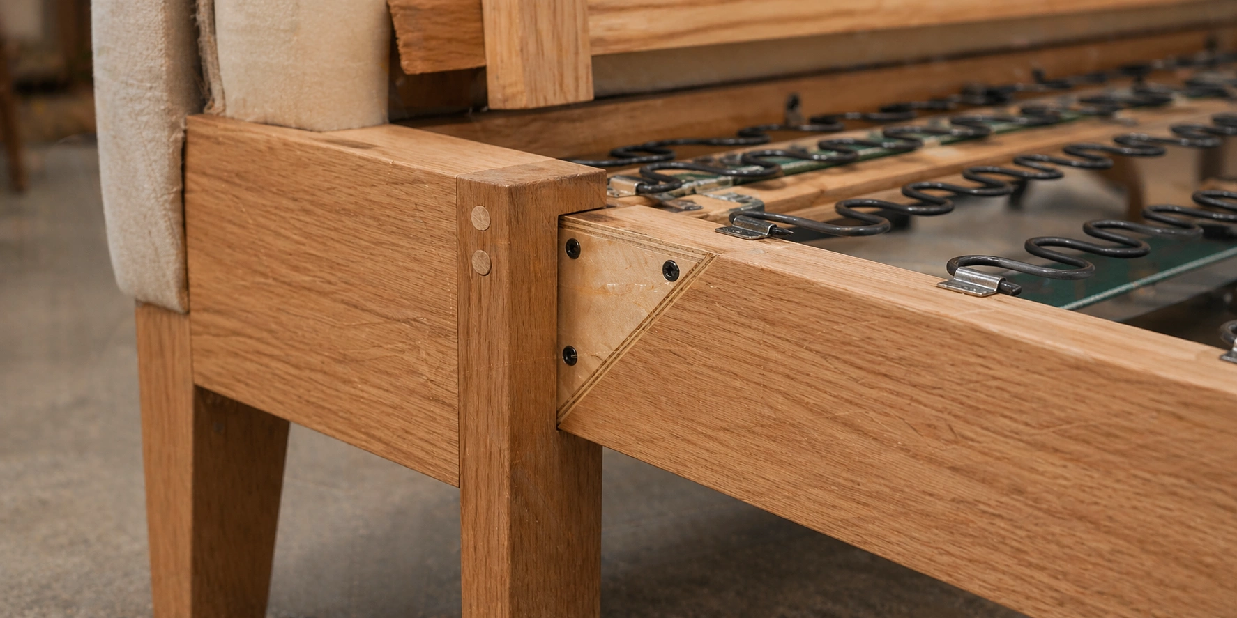 Sofa frame construction showing hardwood joints corner blocks and dowel connections