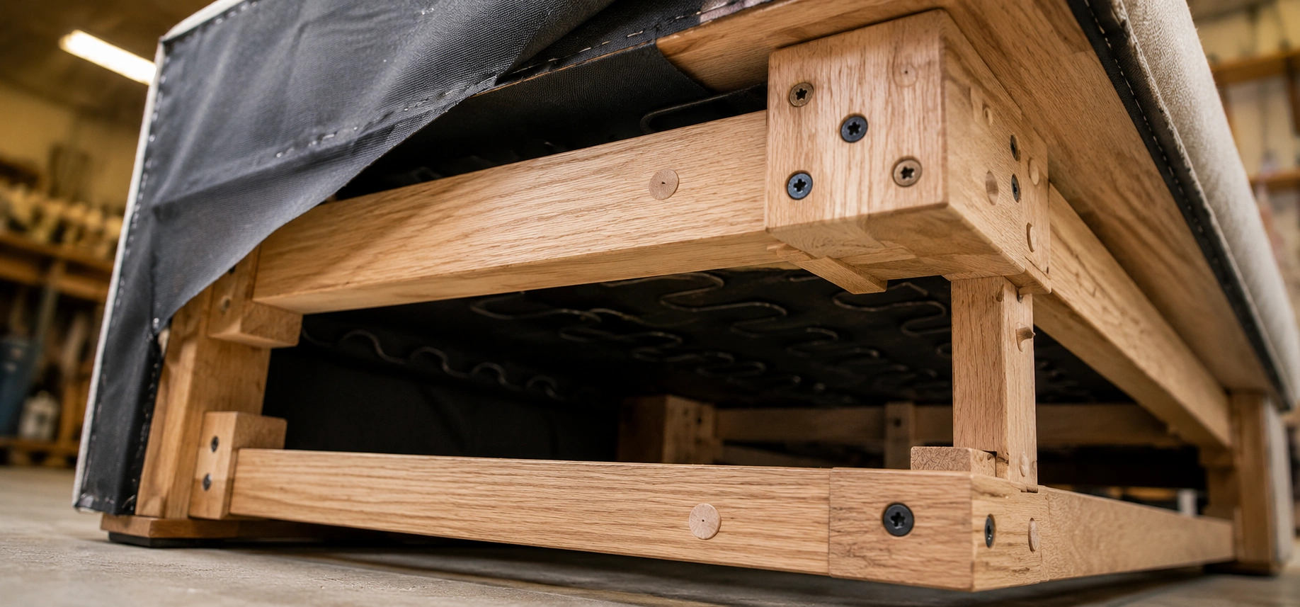 Close-up of sofa frame construction showing corner blocks and hardwood joints