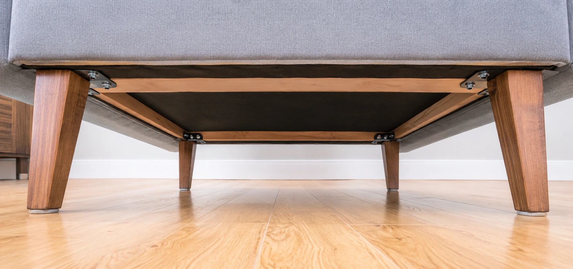 Checking sofa legs and base stability during quality inspection