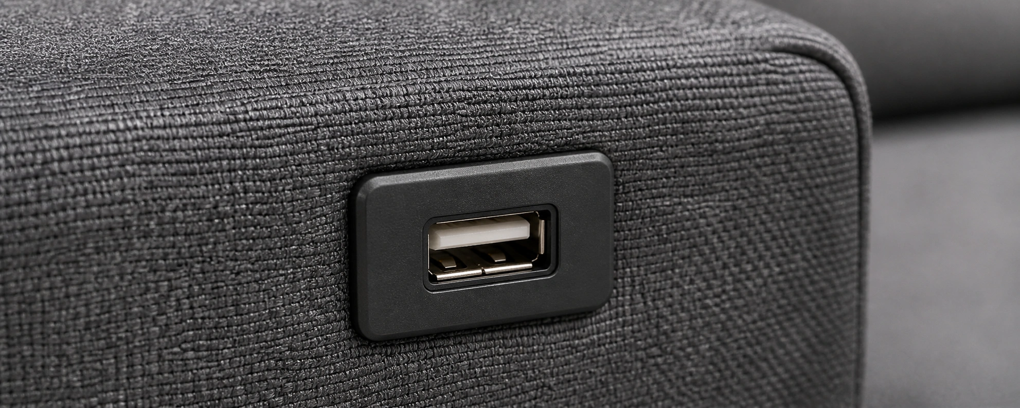Traditional USB-A port on sofa armrest for charging older devices