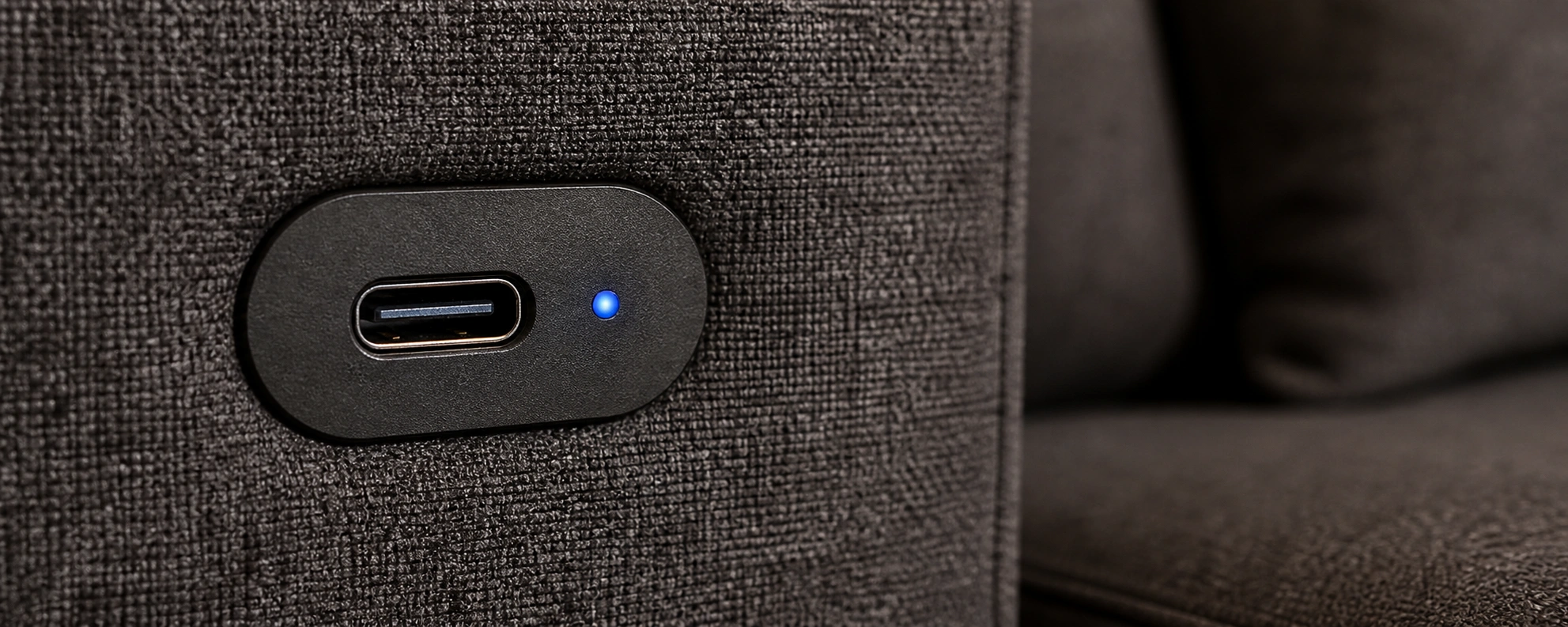 Modern USB-C port on sofa for fast charging smartphones and laptops
