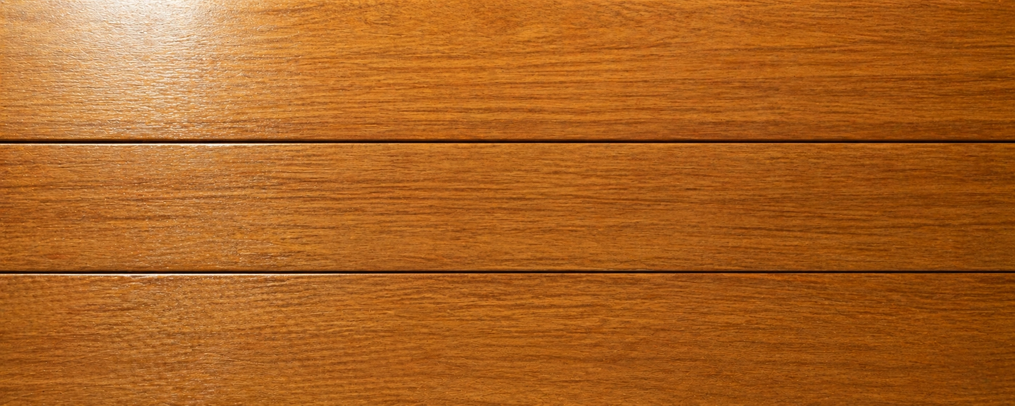 Grade A teak wood showing uniform golden brown heartwood with tight straight grain and no knots