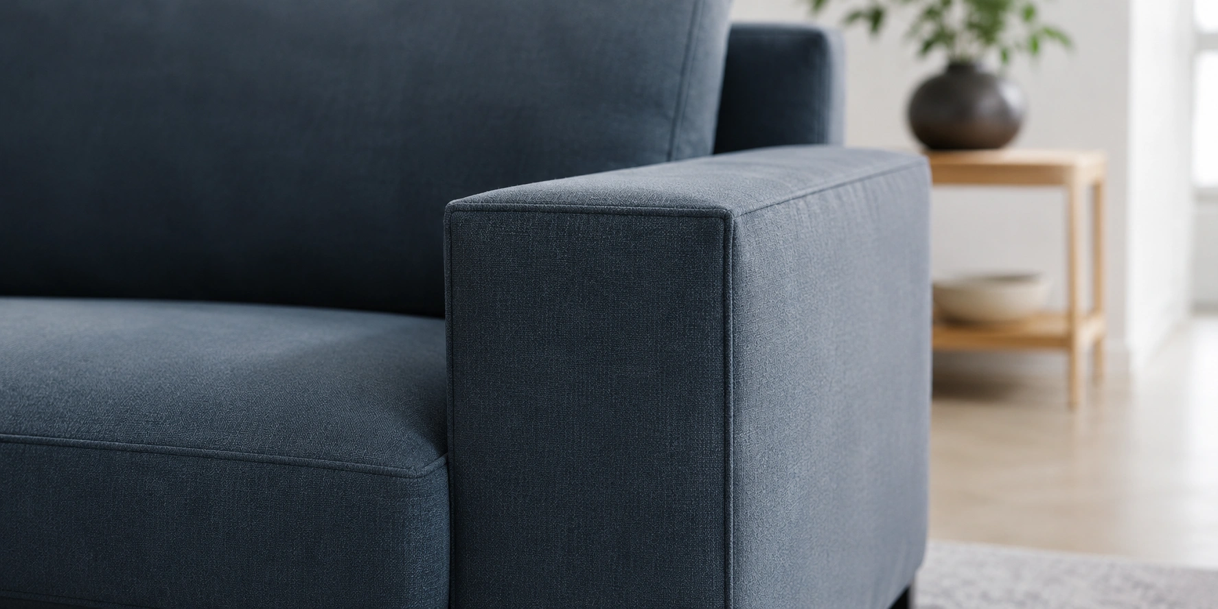 Close-up view of track arms on a modern sofa showing clean straight lines and flat top surface